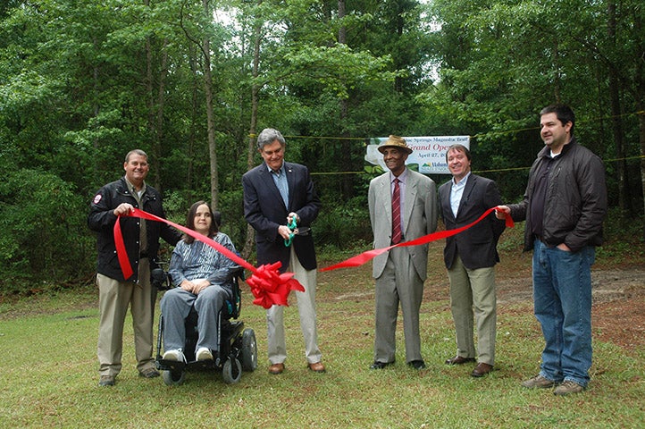 Dignitaries cut the ribbon to open the trail.