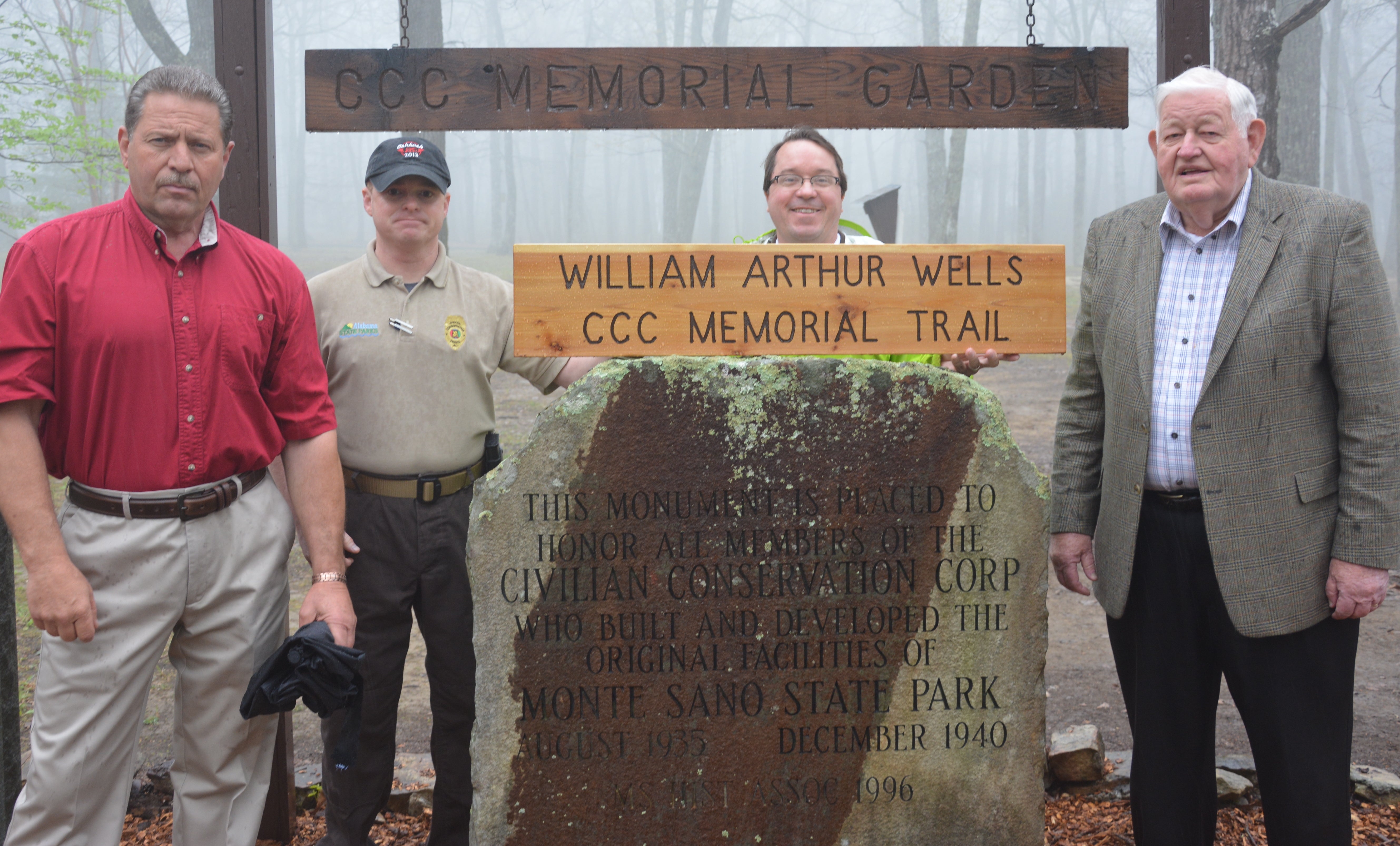 A 1.5-mile trail at Monte Sano State Park was officially renamed the William Arthur Wells Trail in Huntsville on Saturday. Showing off the new trail sign are from left, Chuck Sisco, Park Manager Brian Moore, Alabama State Parks Division Director Greg Lein and Robert Wells. Wells, Sisco and Ricky Underwood donated the 40 acres that the trail crosses to the park.