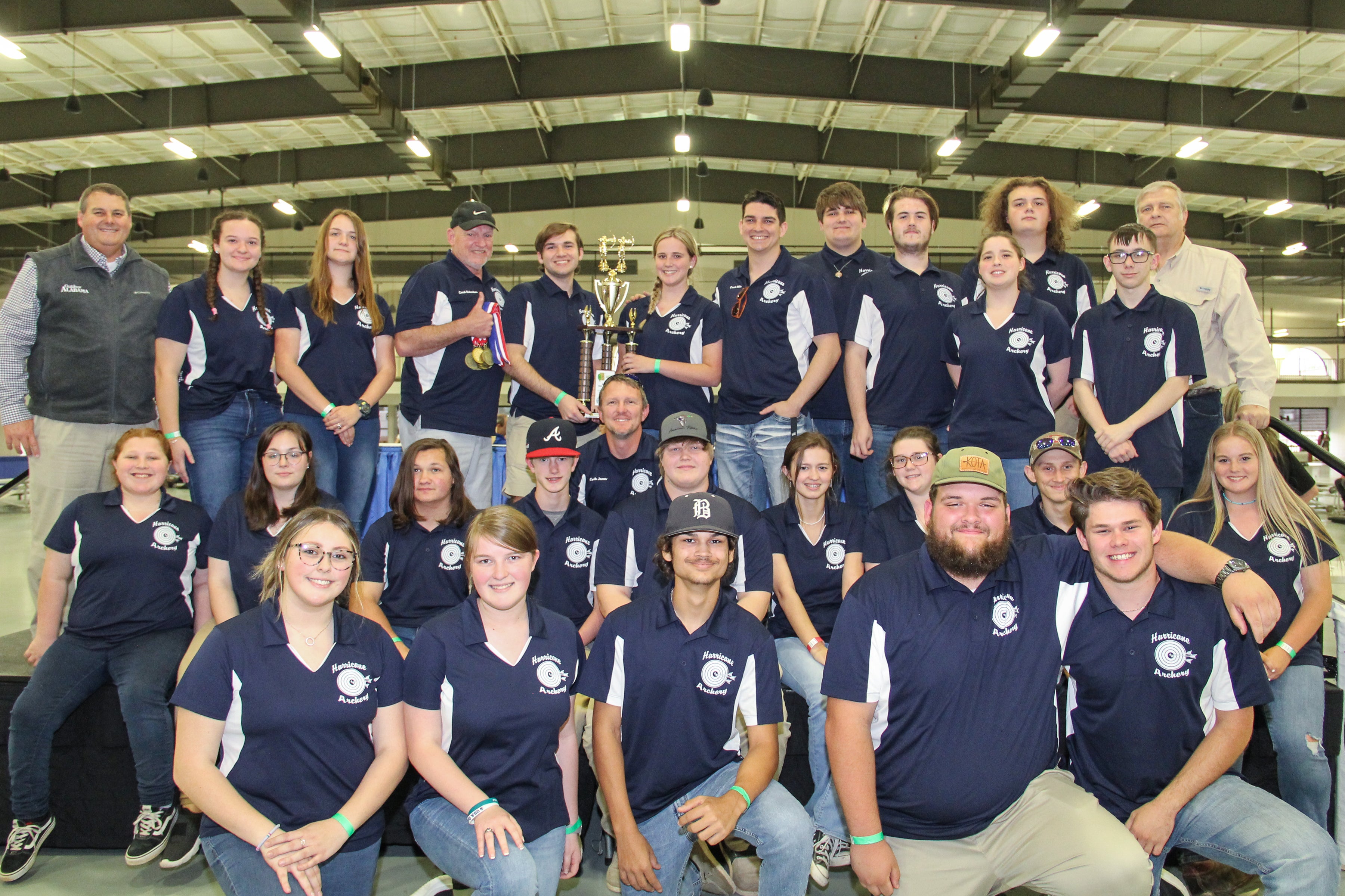 ADCNR Commissioner Chris Blankenship (left) and National Wild Turkey Federation State Chapter President Craig Scruggs (back row, right) with the Alma Bryant Hurricanes Archery Team who took first place in the high school division of the 2022 NASP Alabama State Championship.