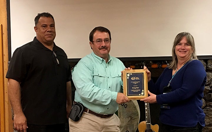 Photo (left to right): AREA committee chairperson Greg Akins, Doug Darr, and AREA President Karen Marks.