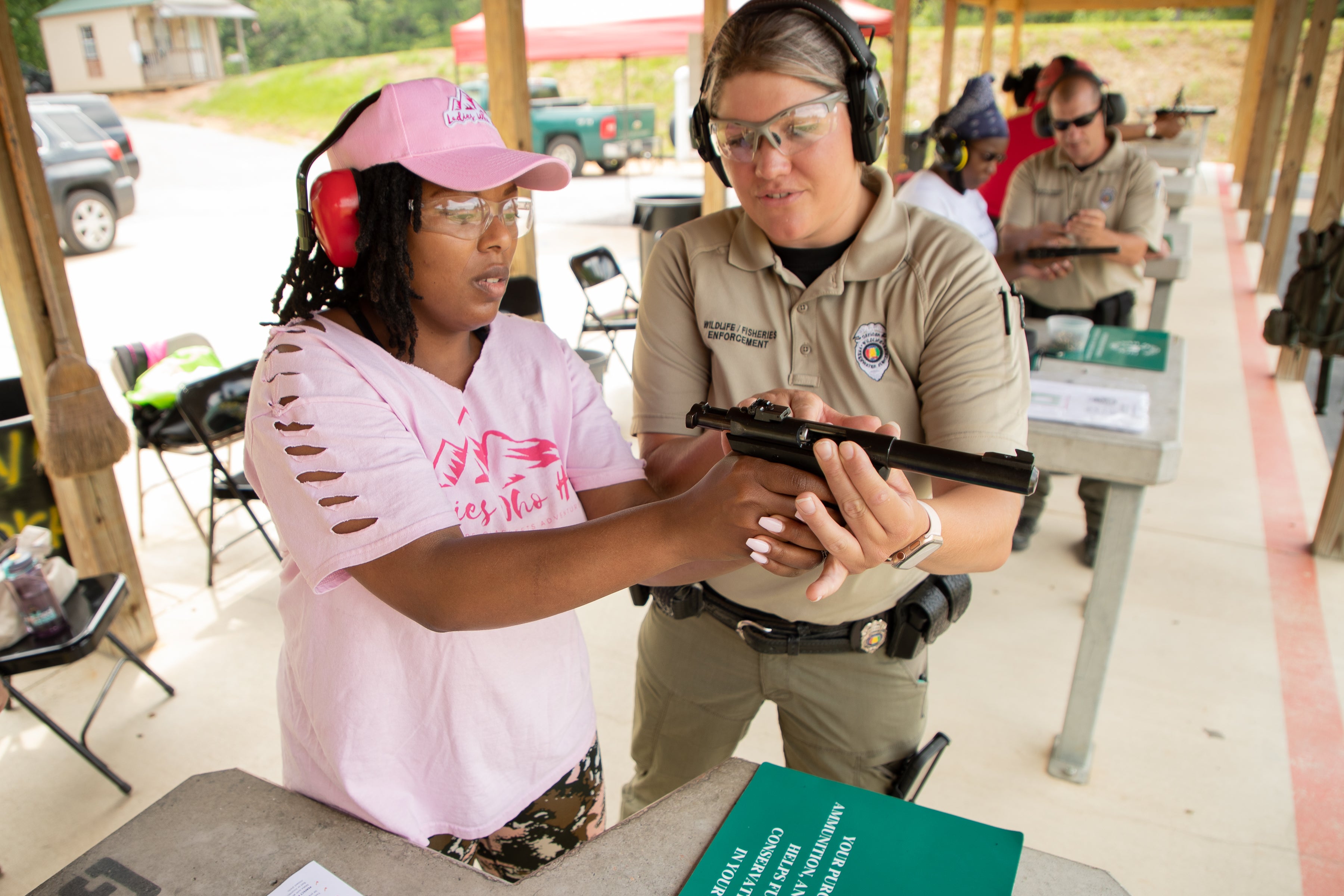 Ladies Who Hike Founder Brittney Davis learns firearm basics during a recent ADCNR Introduction to Handguns class. Photo by Billy Pope, ADCNR