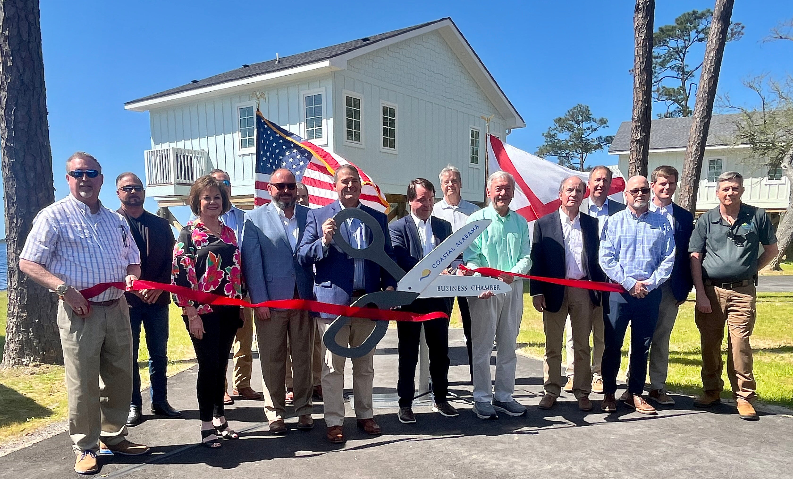 Officials cut the ceremonial ribbon for the new Lakeside Cabins at Gulf State Park on Monday, April 15, 2024.